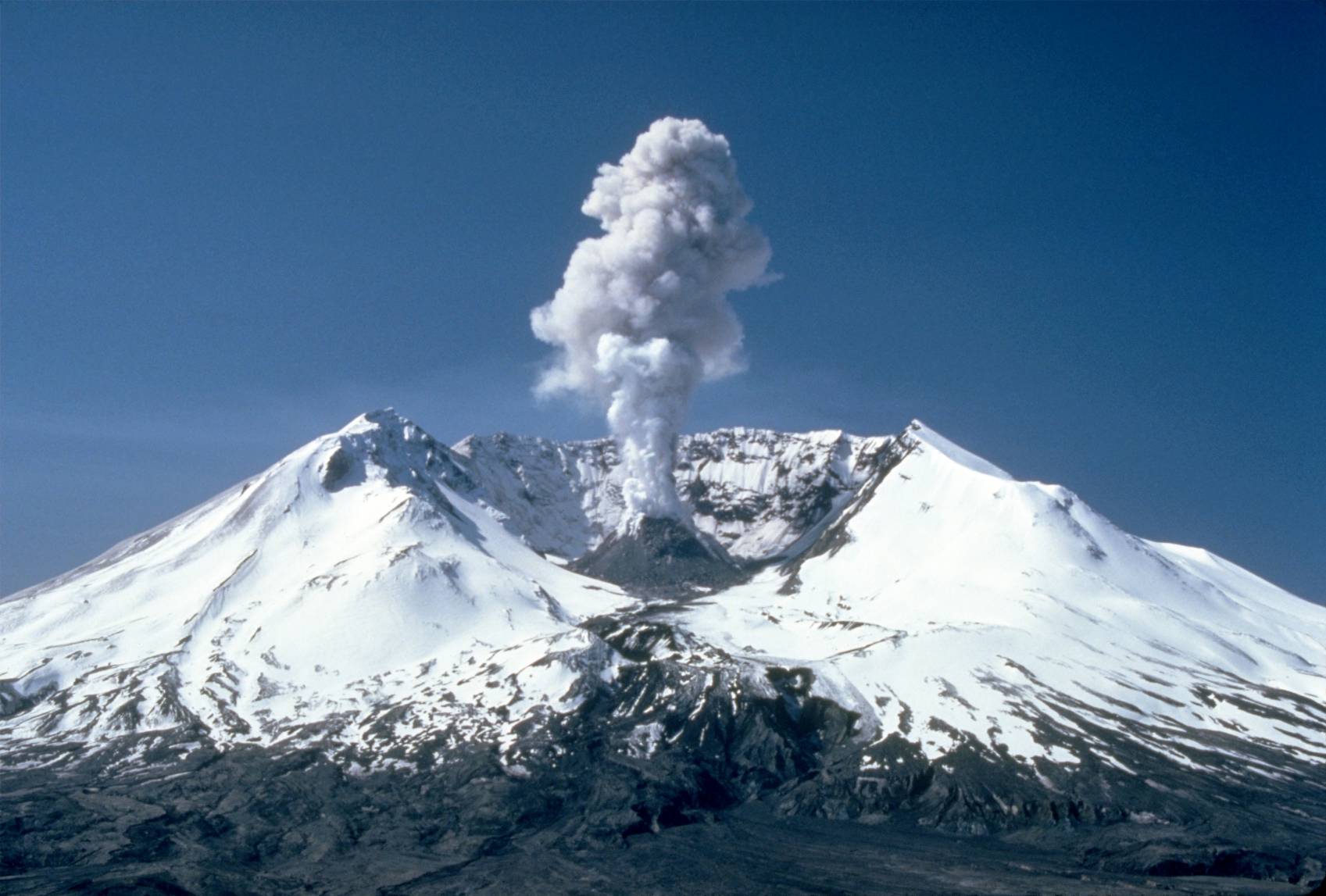 Plumes of steam, gas, and ash often occurred at Mount St. Helens in the early 1980s. On clear days they could be seen from Portland, Oregon, 50 mi (80 km) to the south. The plume photographed here rose nearly 3,000 ft (910 m) above the volcano's rim. The view is from Harrys Ridge, 5 mi (8 km) north of the mountain.